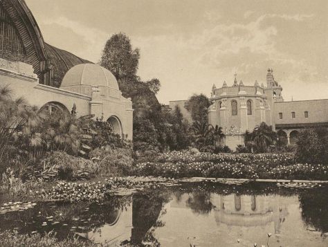 Food Products Building is reflected in tranquil lily pond directly in front of the large lath Botanical Building.