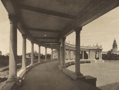 Organ Pavilion colonnade with California Bell Tower in distance. Trees and a large parking exist today on the left, behind the classic structure.
