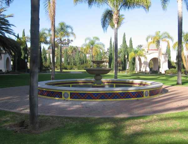 Fountain is near center of a large, quiet grassy space.
