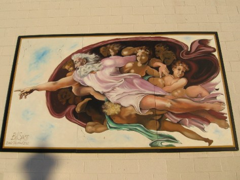 Fragment of the Sistine Chapel on a building wall.