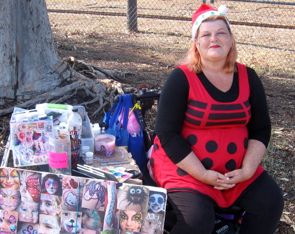 Is this face painter by the Balboa Park carousel Mrs. Claus or a ladybug.