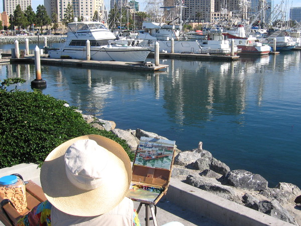 Painter on the Embarcadero inspired by Tuna Harbor boats and reflections.