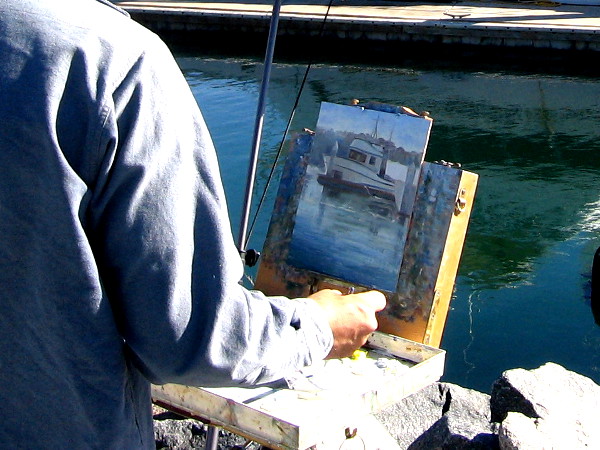 Small painted boat seems to float in the nearby rippled water.