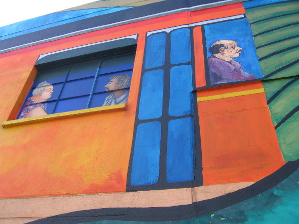 Painted passengers on a trolley seem visible through a window.