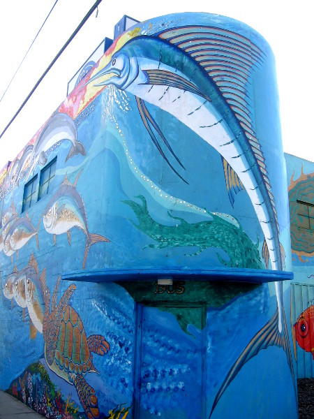 Walking around the mural on the high wall at Restaurant Depot.