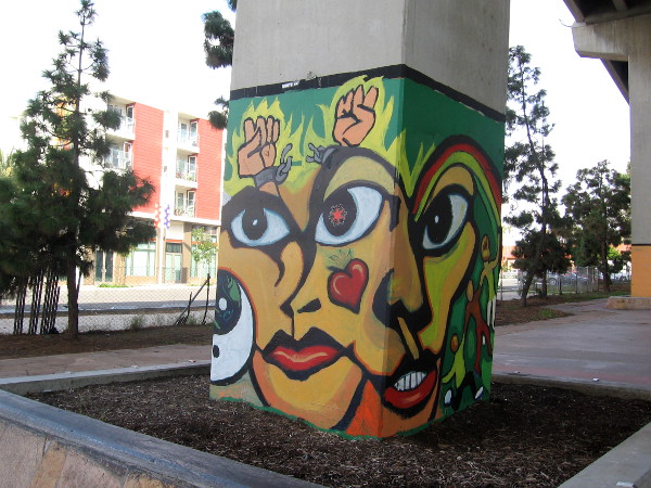 Mercado del Barrio building seen in distance behind a mural in Chicano Park.