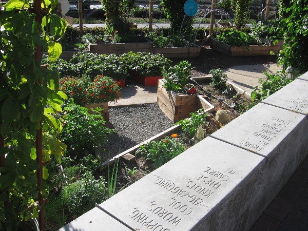 A whimsical poem is inscribed on a long wall enclosing the small garden.