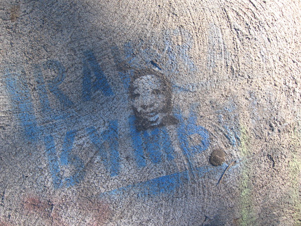 Small grinning face in some faded blue words.