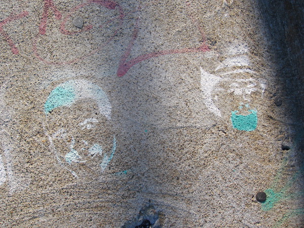 These stenciled faces seem to be slowly disappearing as time passes.