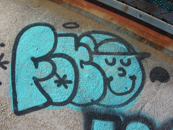 Another smiling face in graffiti on the lonely bridge.