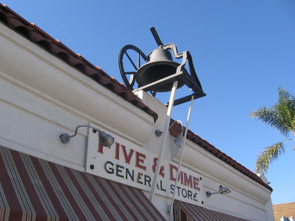 An old church bell is mounted on the roof of Old Town's Five and Dime General Store.