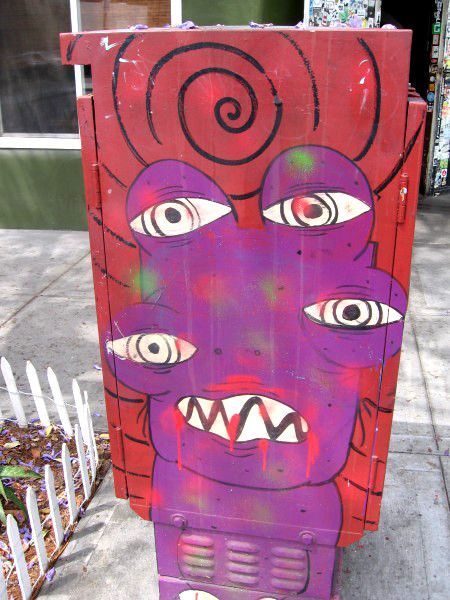 Creature with four eyeballs and crooked teeth.