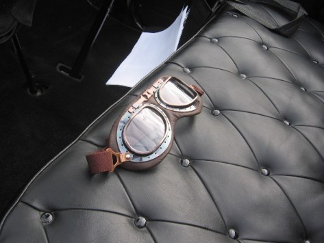 Racing goggles lie ready on leather seat. The road rally will begin in a few minutes!