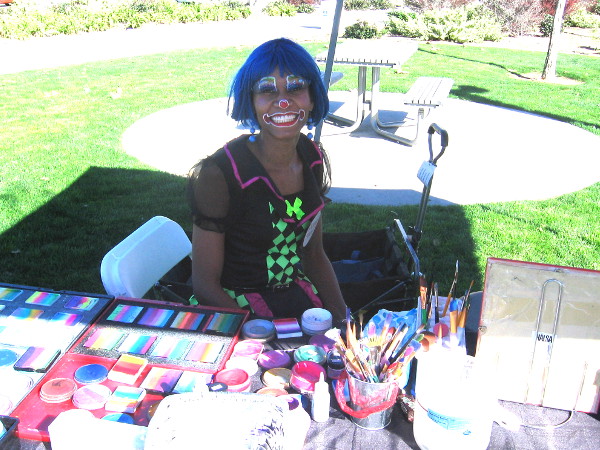 Young lady with awesome smiling painted face was decorating other folks!