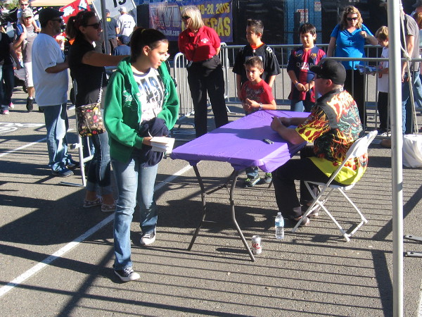 I guess this is a driver. He was signing autographs for lots of fans.