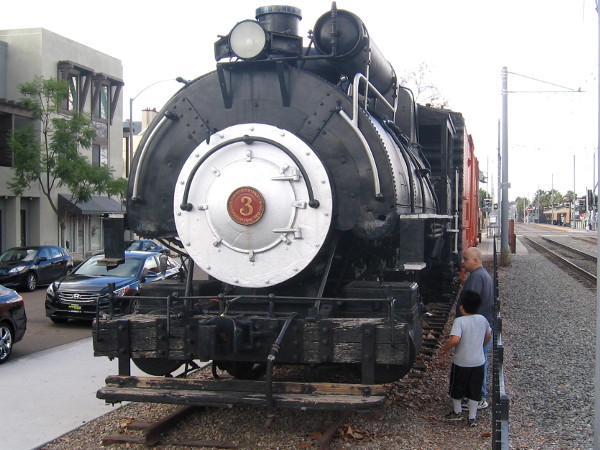 Dad and son check out old steam locomotive on display at La Mesa Depot Museum.