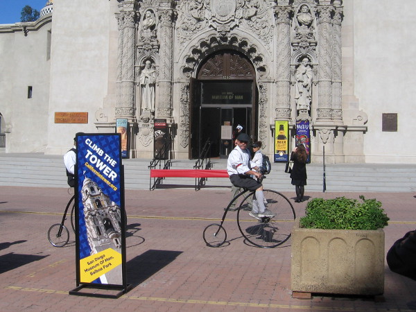 Several cool bicyclists happened to ride down El Prado in front of the Museum of Man.