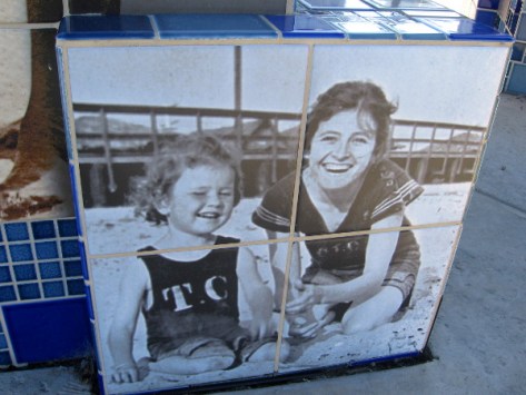 Small child and mom have fun in the sand.