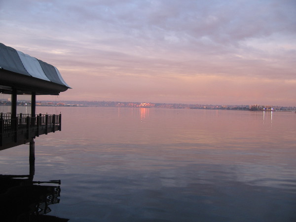 January sunrise tints calm water of San Diego Bay.