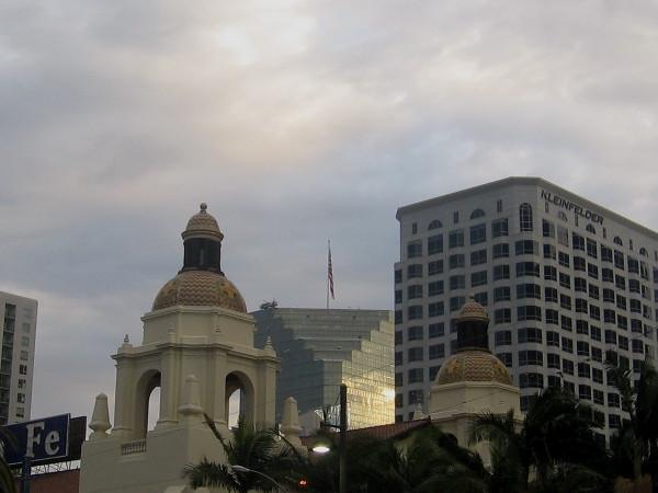 Sunlight reflects from silvery skyscraper beyond domes of the Santa Fe Depot.
