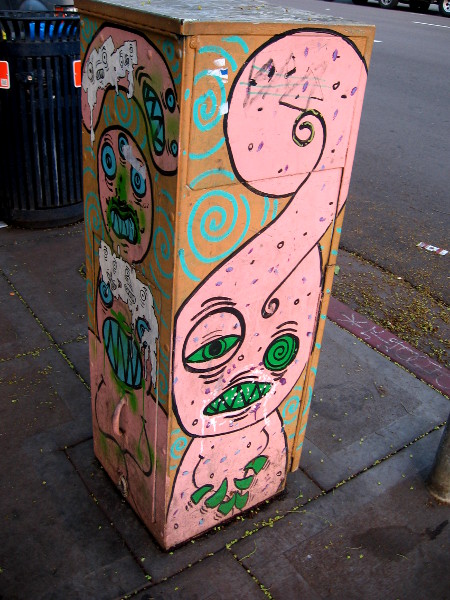 Pink monster with messed up green eyes.
