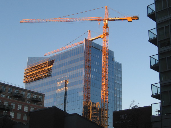 A rising skyscraper shines brightly in the early morning.