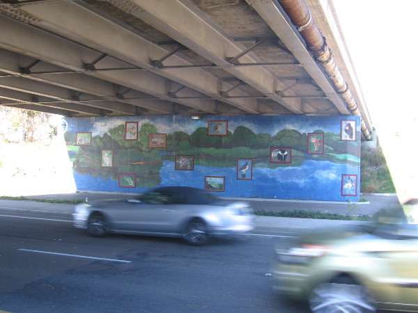 Cars zoom west down Friars Road, beneath the Morena Boulevard bridge.