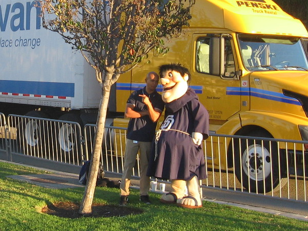 San Diego Padres baseball mascot Swinging Friar near truck about to leave for Peoria.
