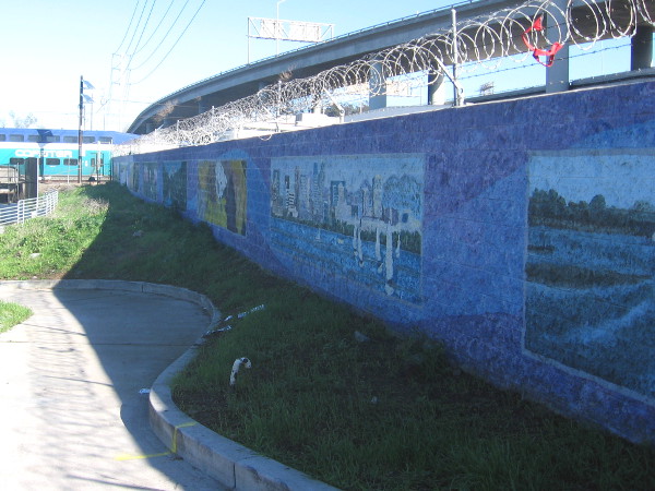 Public art along the San Diego River Trail near Pacific Highway. The Coaster train can be seen passing across one of the rail bridges.
