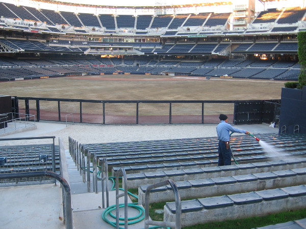 Hosing down seats behind the Beach. The ball field is being prepped for professional baseball after the recent Monster Jam event.