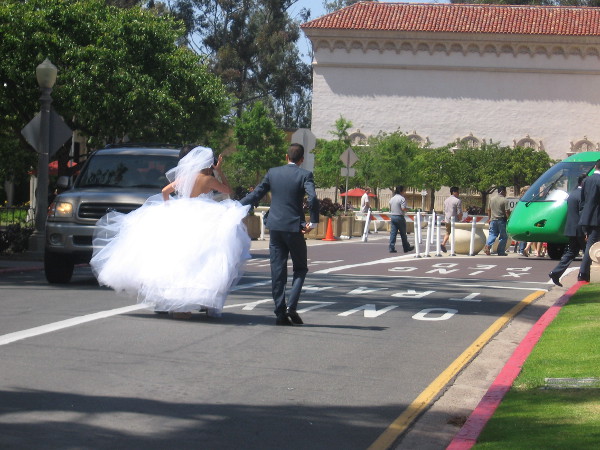 New bride and groom hustle through the heart of Balboa Park.