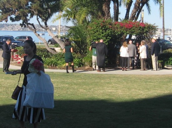 The first ceremony takes places at the small wedding arbor in the waterfront park.
