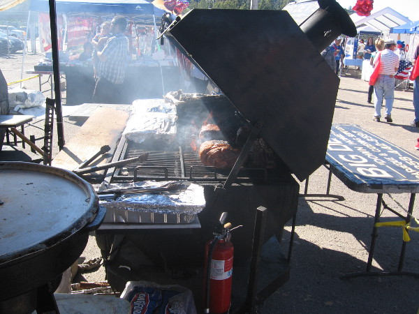 Lots of tasty barbeque was getting ready on this big grill.
