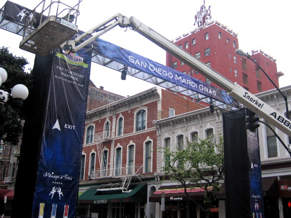 Putting up big Mardi Gras arches along Fifth Avenue in San Diego's Gaslamp.
