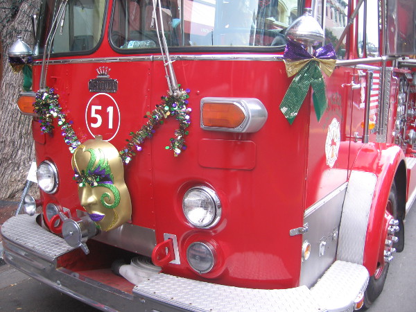 Three old firetrucks were decorated with Mardi Gras masks and ornaments.