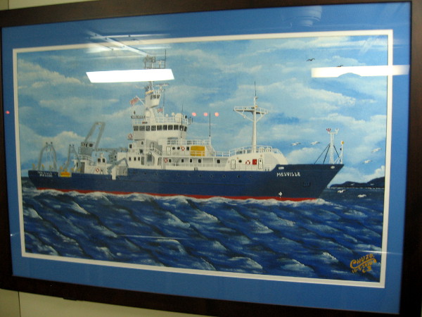 Painting by artist Chuzo of the Melville hangs in a corridor near some stairs below deck.