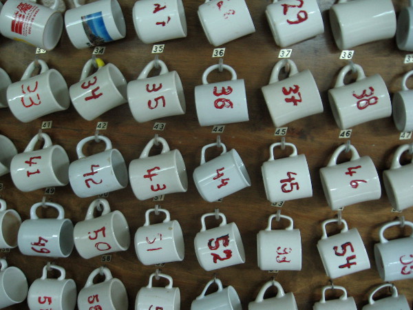 Numbered mugs on the mess hall wall. Number 1 belongs to the captain.