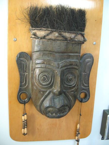 Several masks, ethnic artifacts and marine objects decorate the walls of the cafeteria.