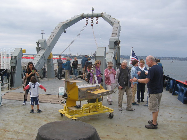 Massive A-frame at stern of Melville. The working deck contains exhibits for people to check out.