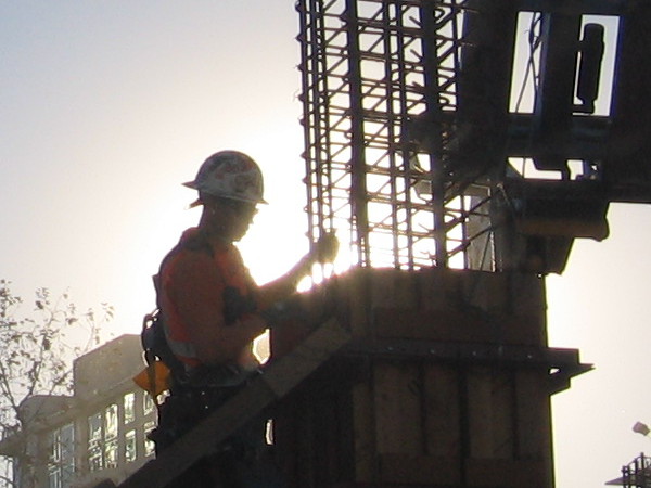 Silhouette of worker as morning sun lights the downtown San Diego sky.
