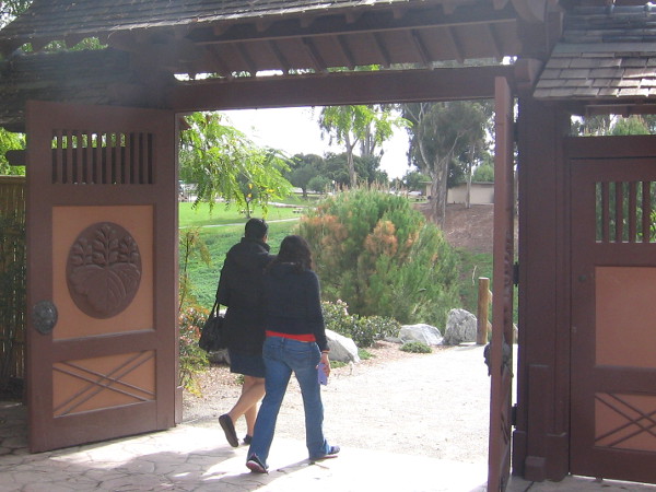 Visitors head down a fairly easy hiking trail to see the cherry blossoms and other flowers.