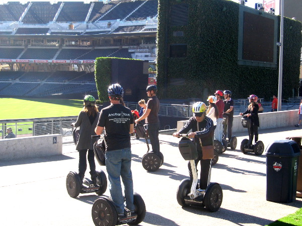 Tour group on Segways stops in Petco's Park at the Park to gaze at empty field.