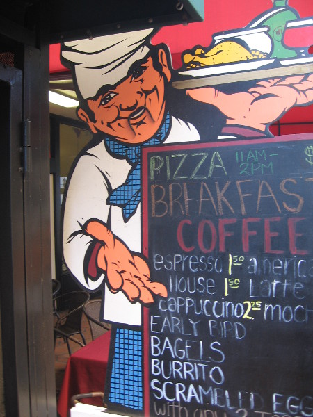 Cook on Sixth Avenue proudly shows his chalkboard menu.