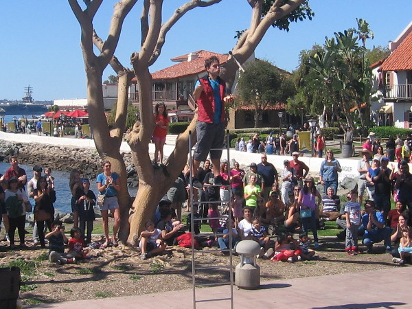 Alex Clark, with training from Cirque Du Soleil, balances atop ladder while juggling knives.