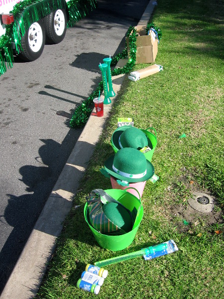 Fun green hats and stuff line the grass by the sidewalk.