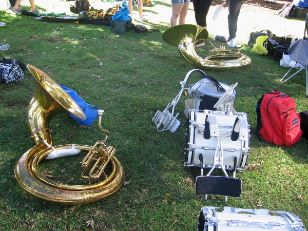Marching band instruments lie on the grass before start of the St. Paddy's parade.