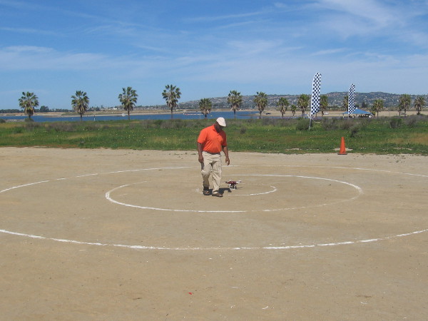 Guy sets his drone down in preparation for a demonstration.