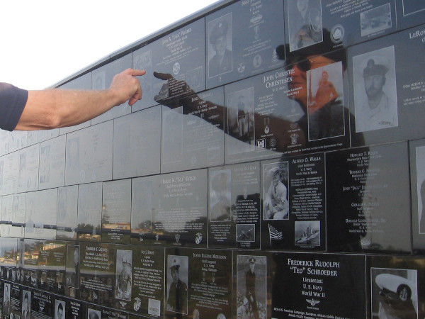 Pointing out notable names and heroic exploits that shine on the walls.