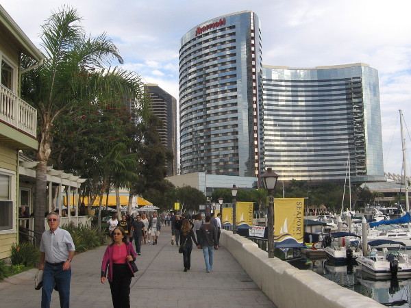 People walk near the Marriott Marina on the sun-drenched Embarcadero.