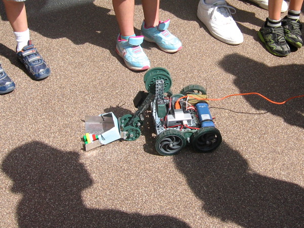 People were jumping about as this robot dashed about scooping stuff up.